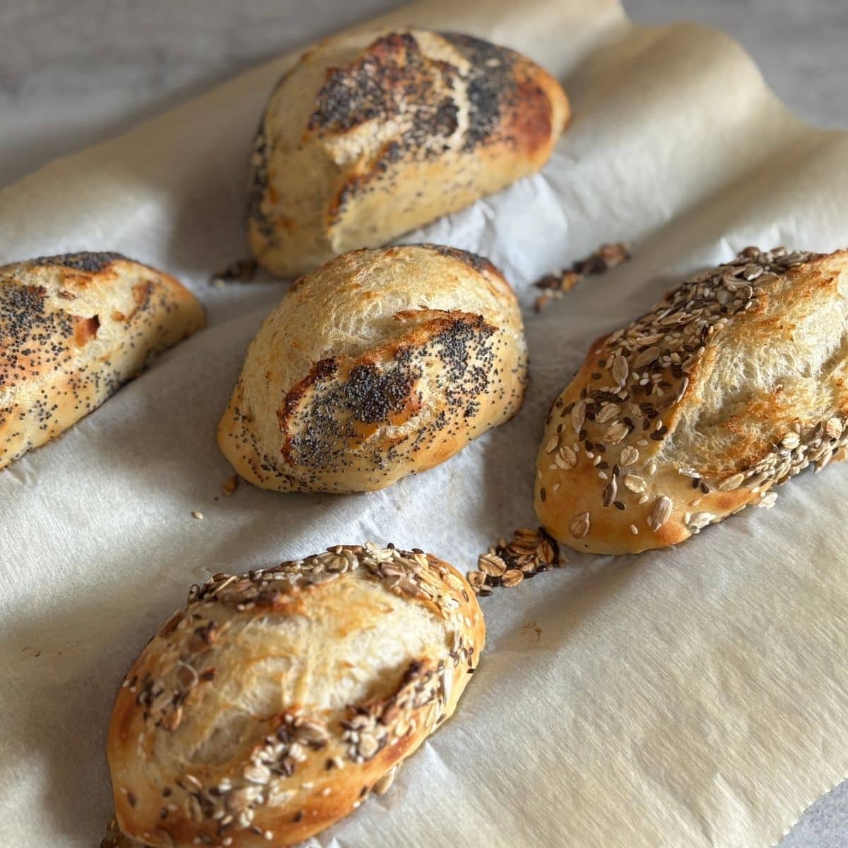 German Bread Rolls on Baguette Tray with Poppyseeds and Sesame Seeds