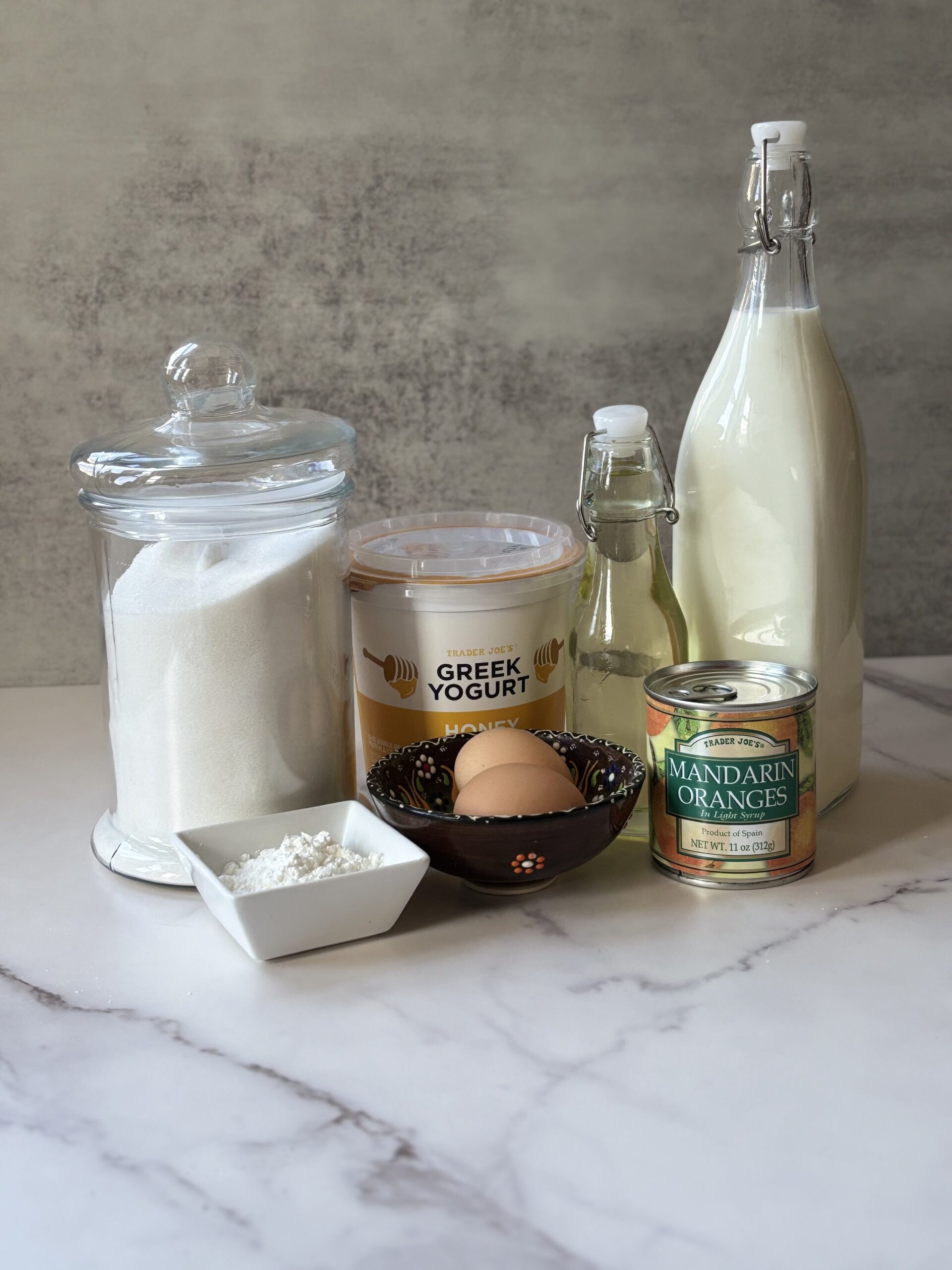 Culinary ingredients: yogurt, milk, sugar, eggs, oranges.