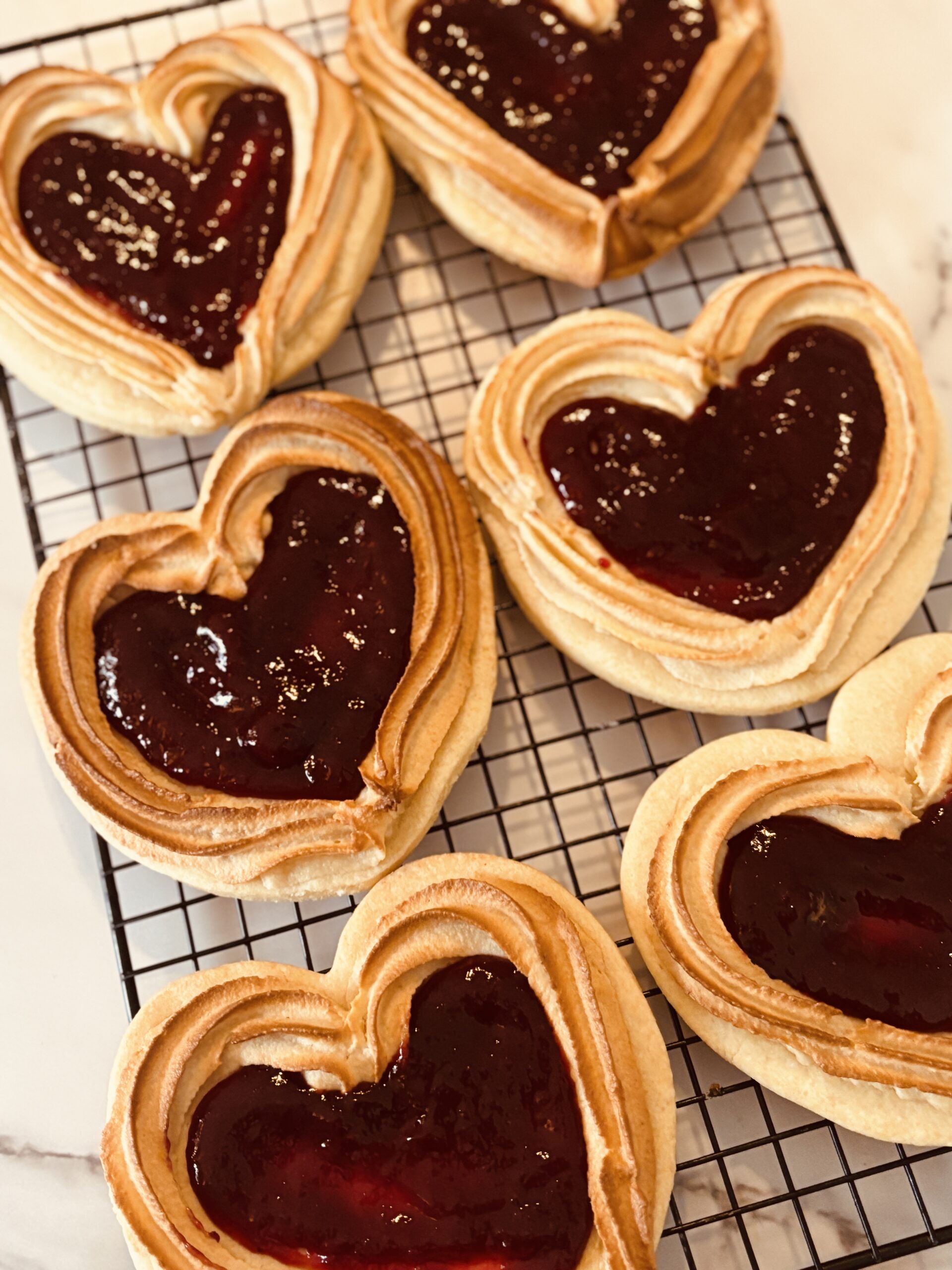 Heart-shaped pastries with berry jam filling.