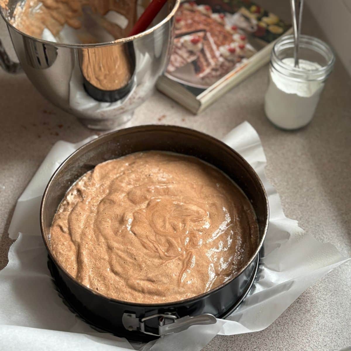 Chocolate sponge cake batter for German Black Forest cake in a cake pan before baking