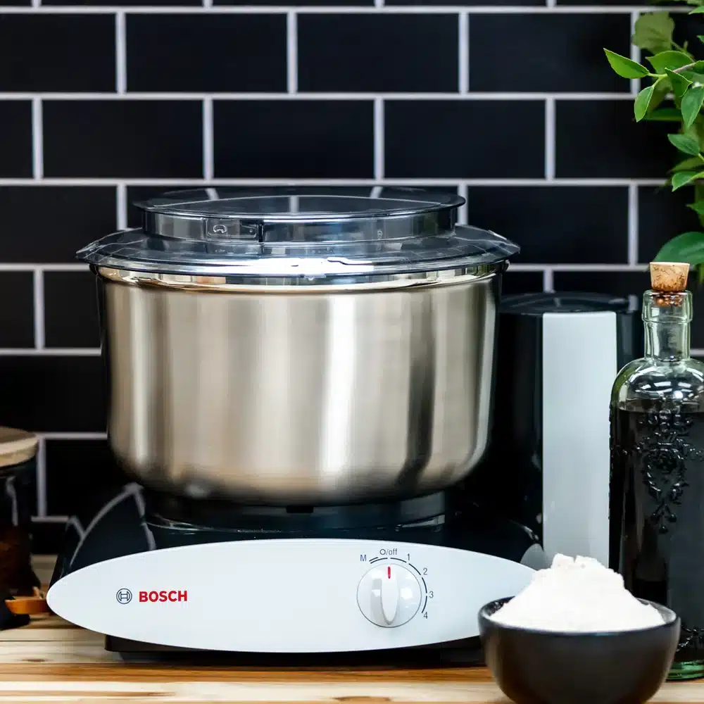 Bosch mixer on kitchen counter with flour bowl.
