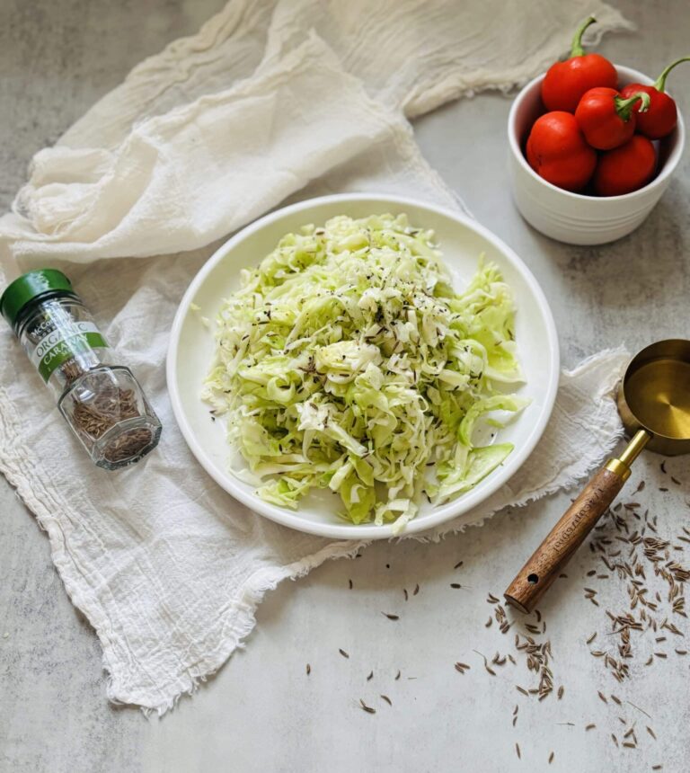 Fresh cabbage salad with caraway seeds and tomatoes.
