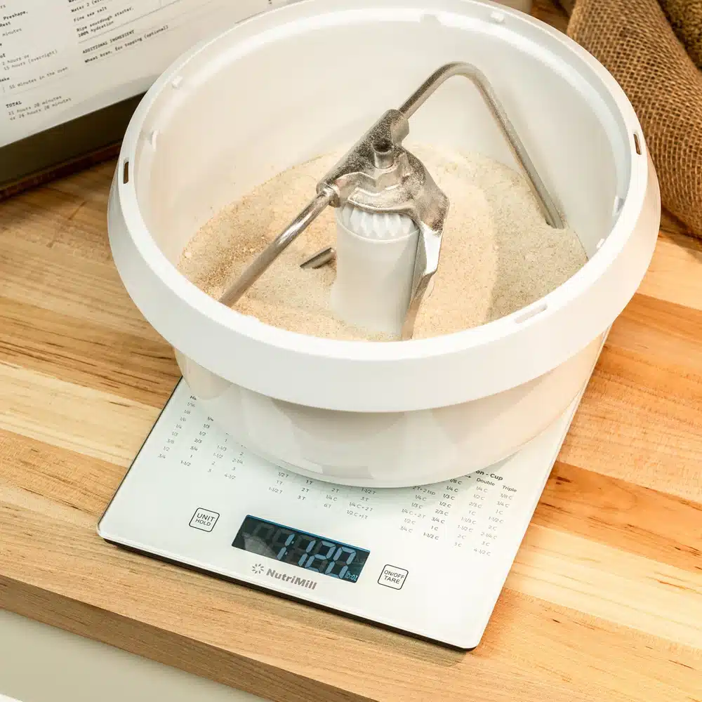 Baking mixer on digital kitchen scale.