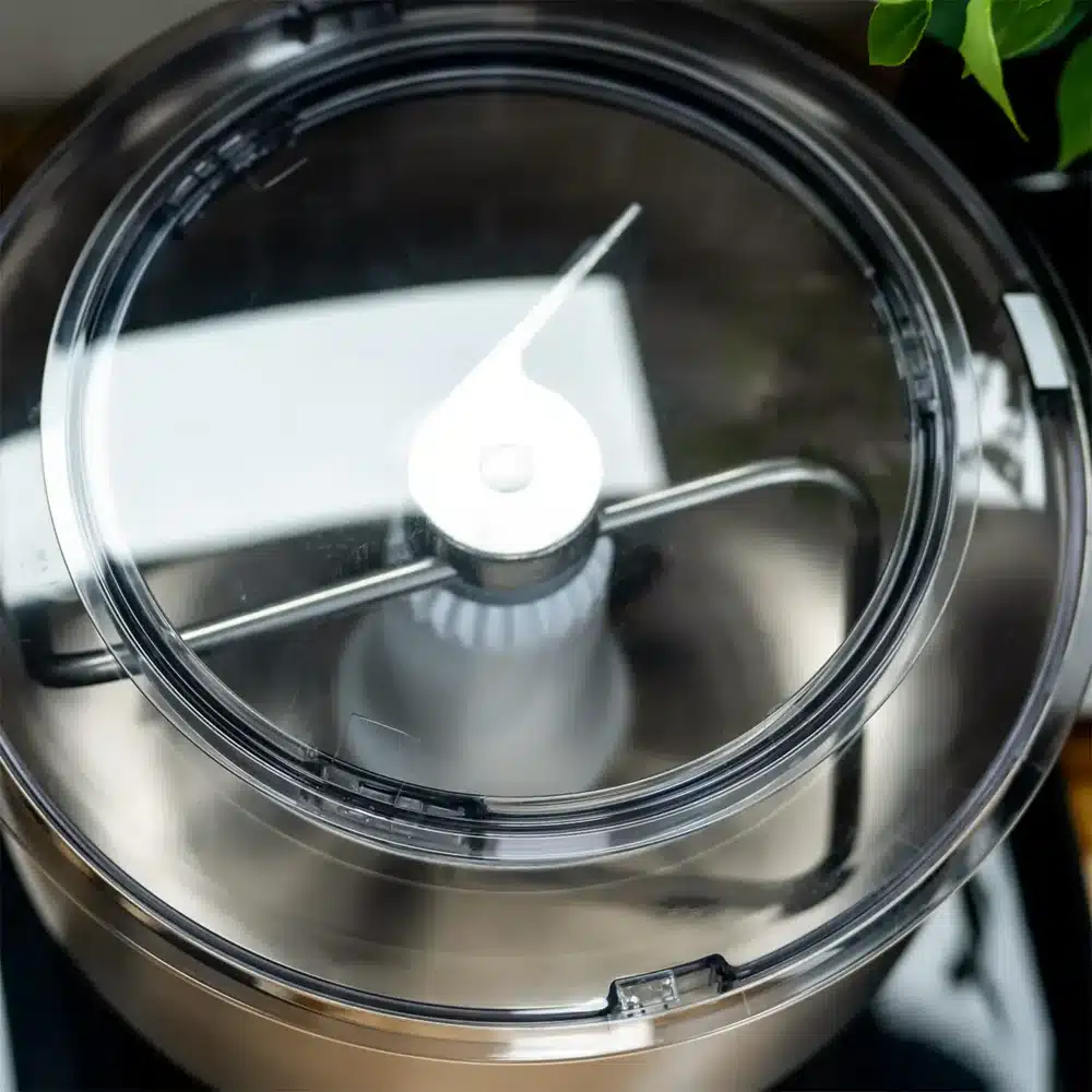 Overhead view of food processor lid with blades.
