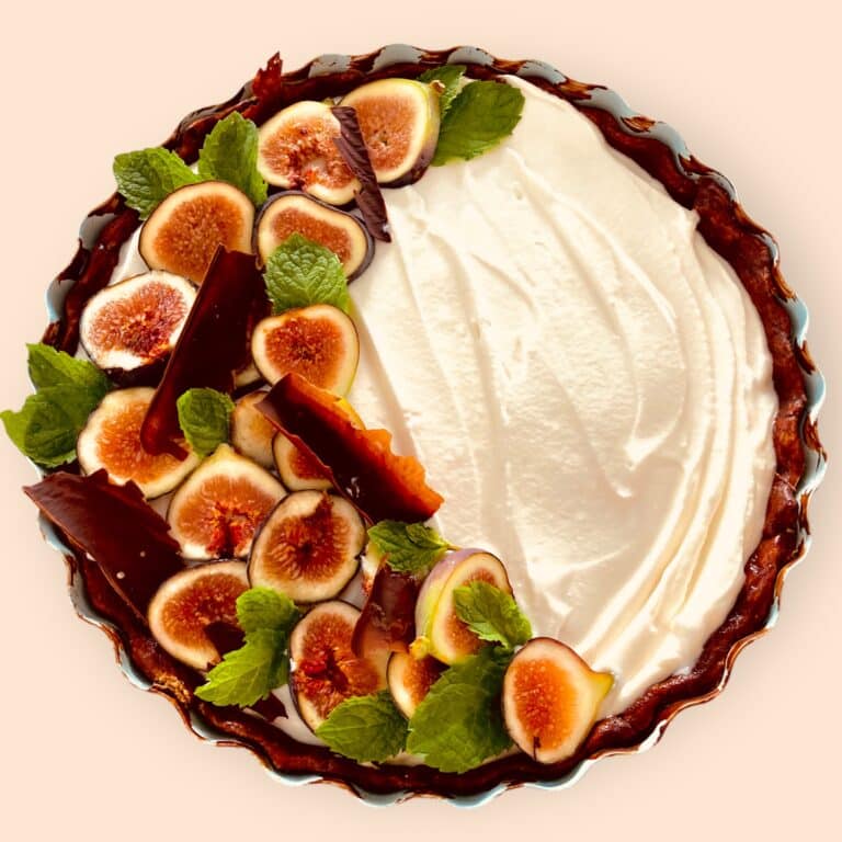 Fig tart with whipped cream and mint.