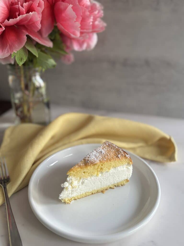 Slice of cake with pink flowers and napkin