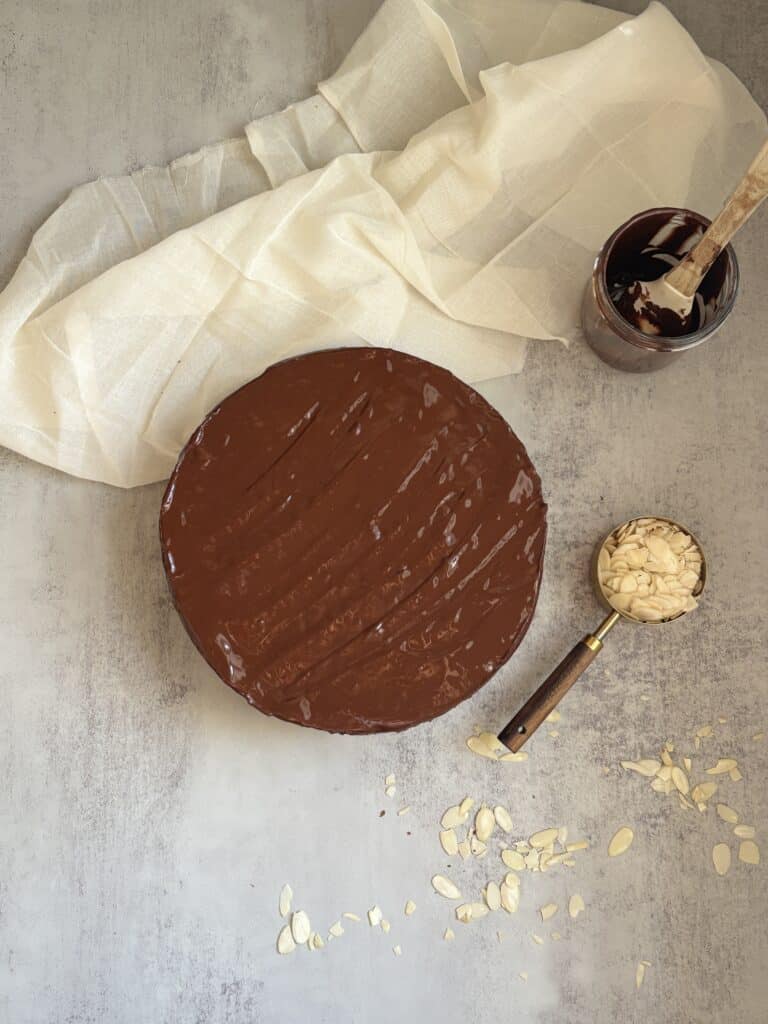 Chocolate cake with almonds and frosting jar.