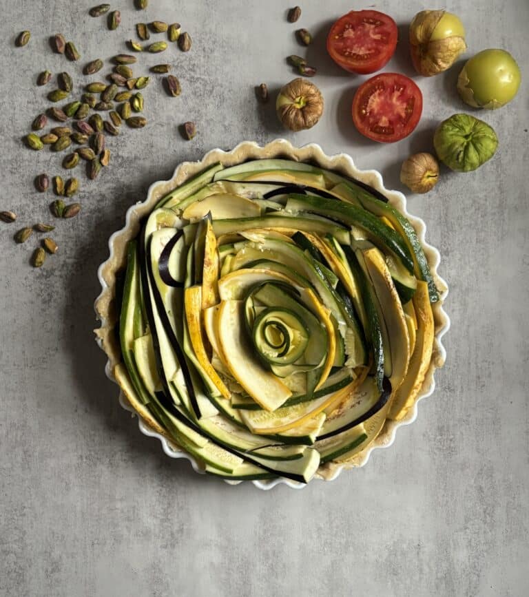 Colorful vegetable tart with zucchini and pistachios.