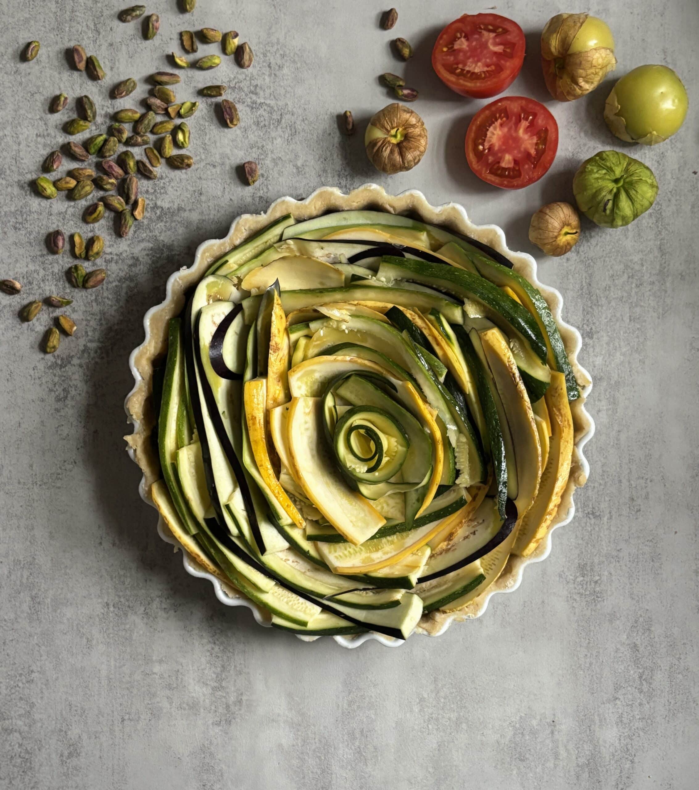 Colorful vegetable tart with zucchini and pistachios.