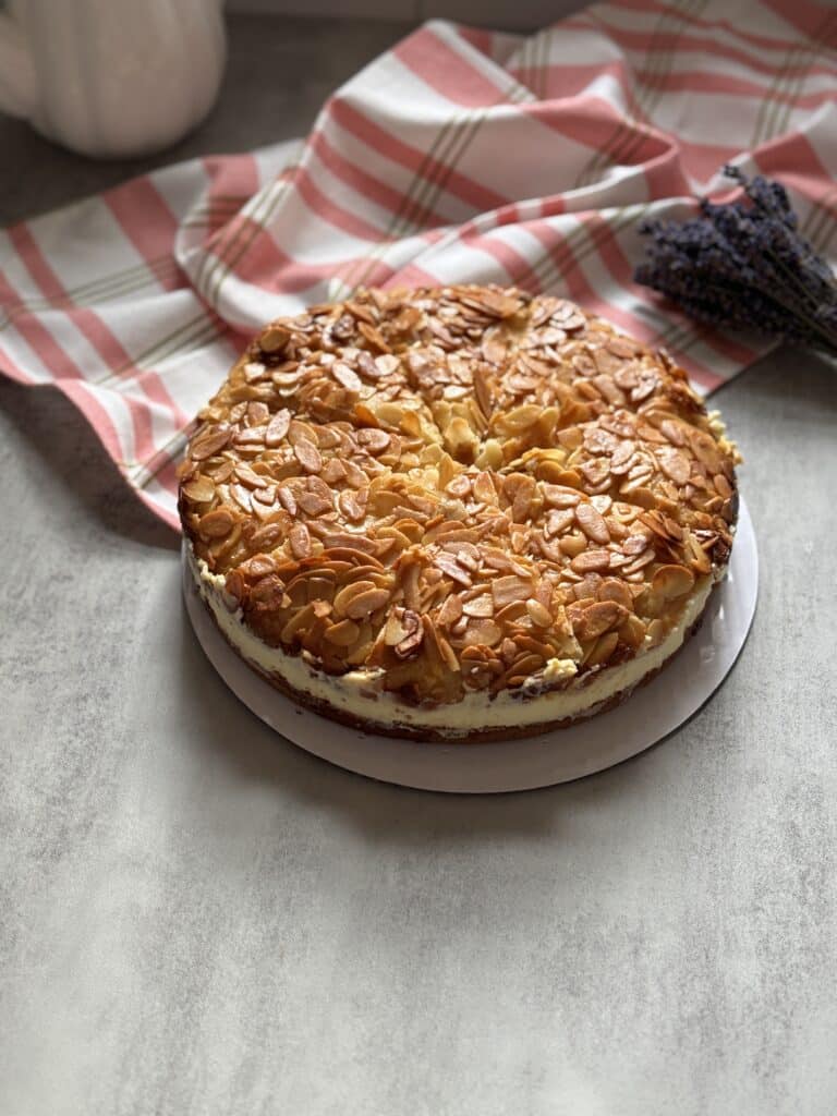 Homemade almond cake on table with checkered cloth