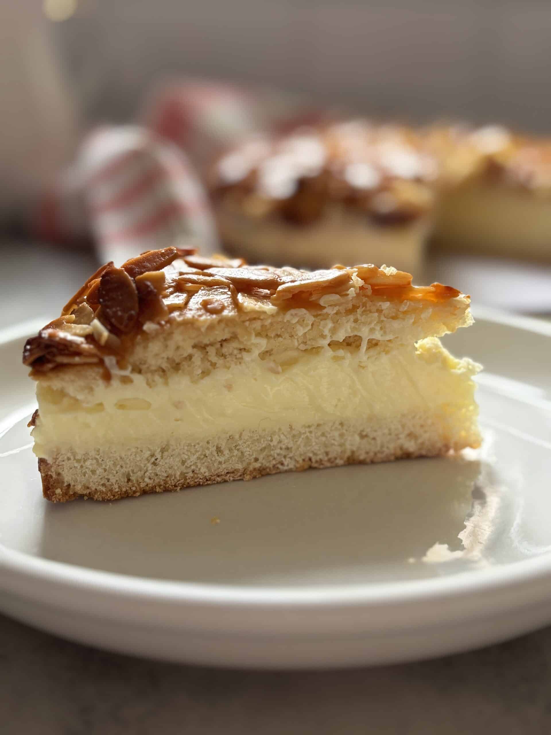 Slice of creamy almond cake on plate