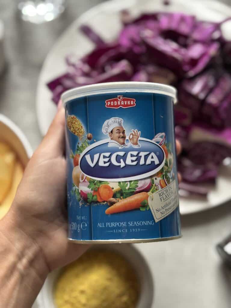 Hand holding Vegeta seasoning can close-up.