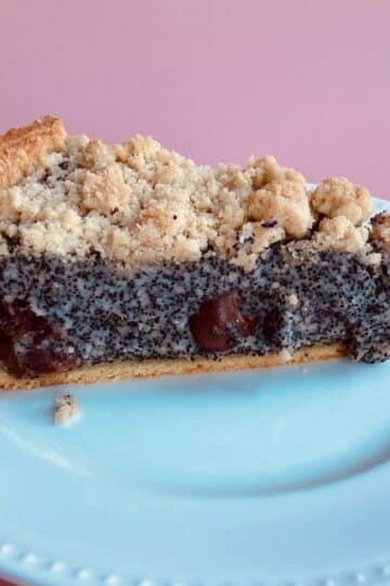 Poppy Seed Streusel Cake with Cherries on a White Plate