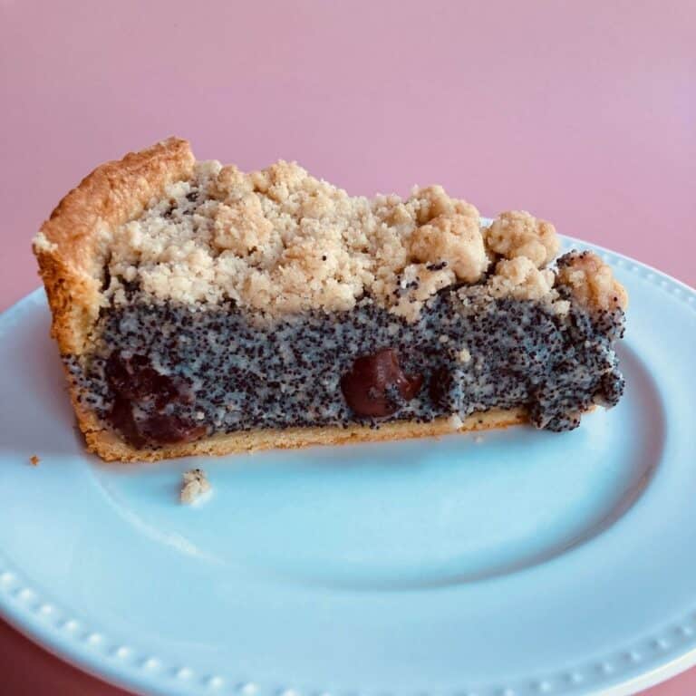 Poppy Seed Streusel Cake with Cherries on a White Plate
