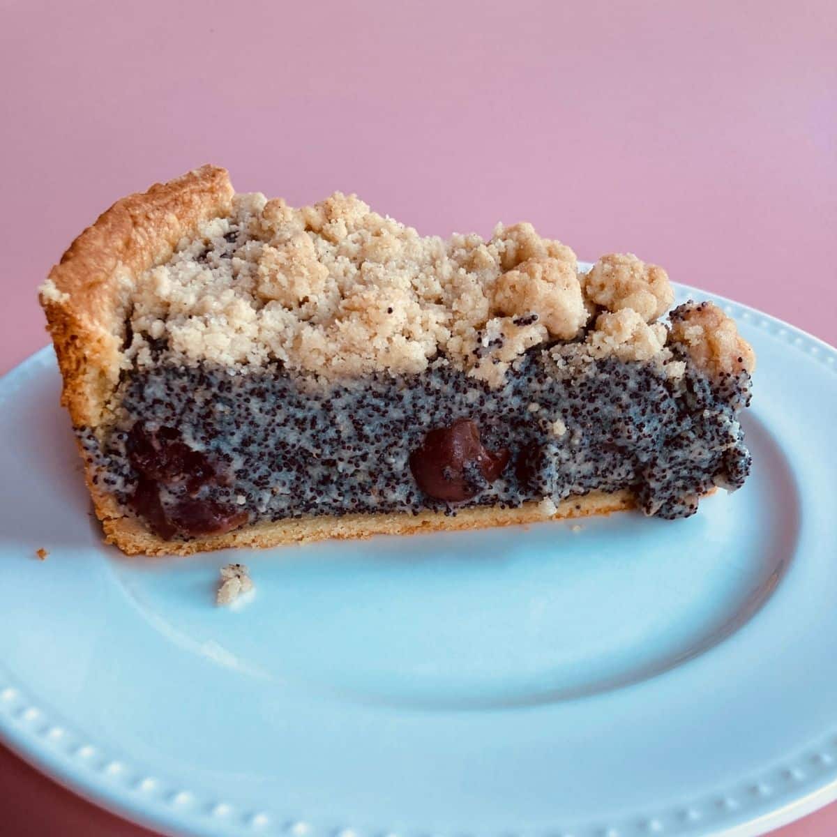 Poppy Seed Streusel Cake with Cherries on a White Plate