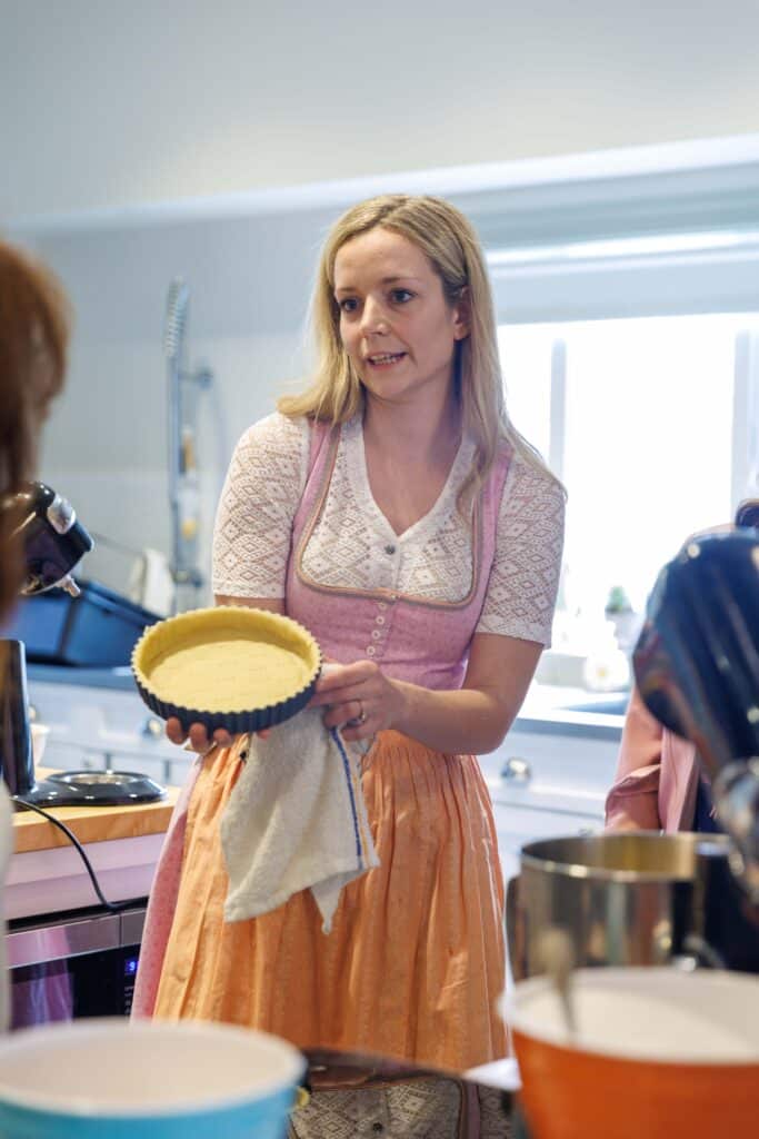 Woman holding pie crust in kitchen