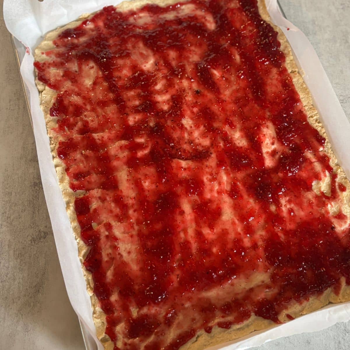Dough with Jam Spread on Baking Tray