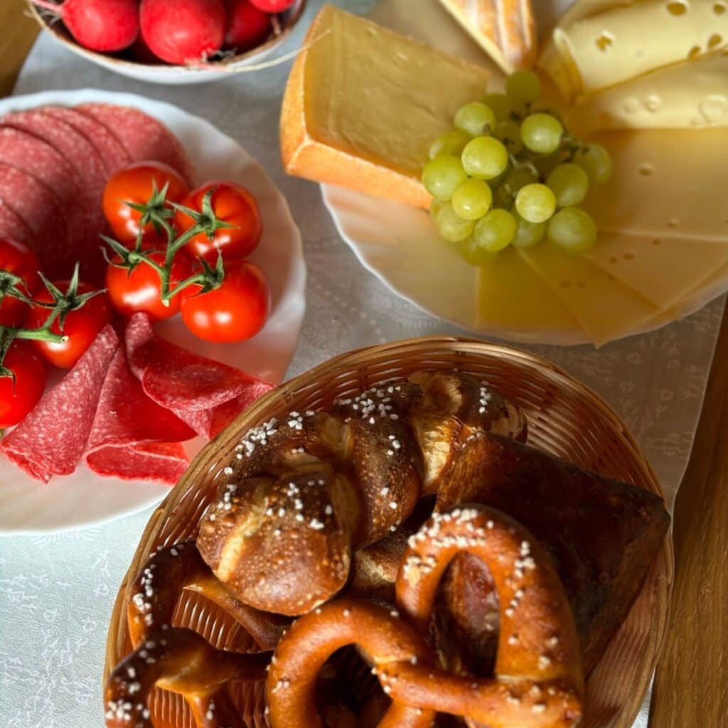 German Breakfast with Pretzels, sliced meats, cheese and fruit and veggies.
