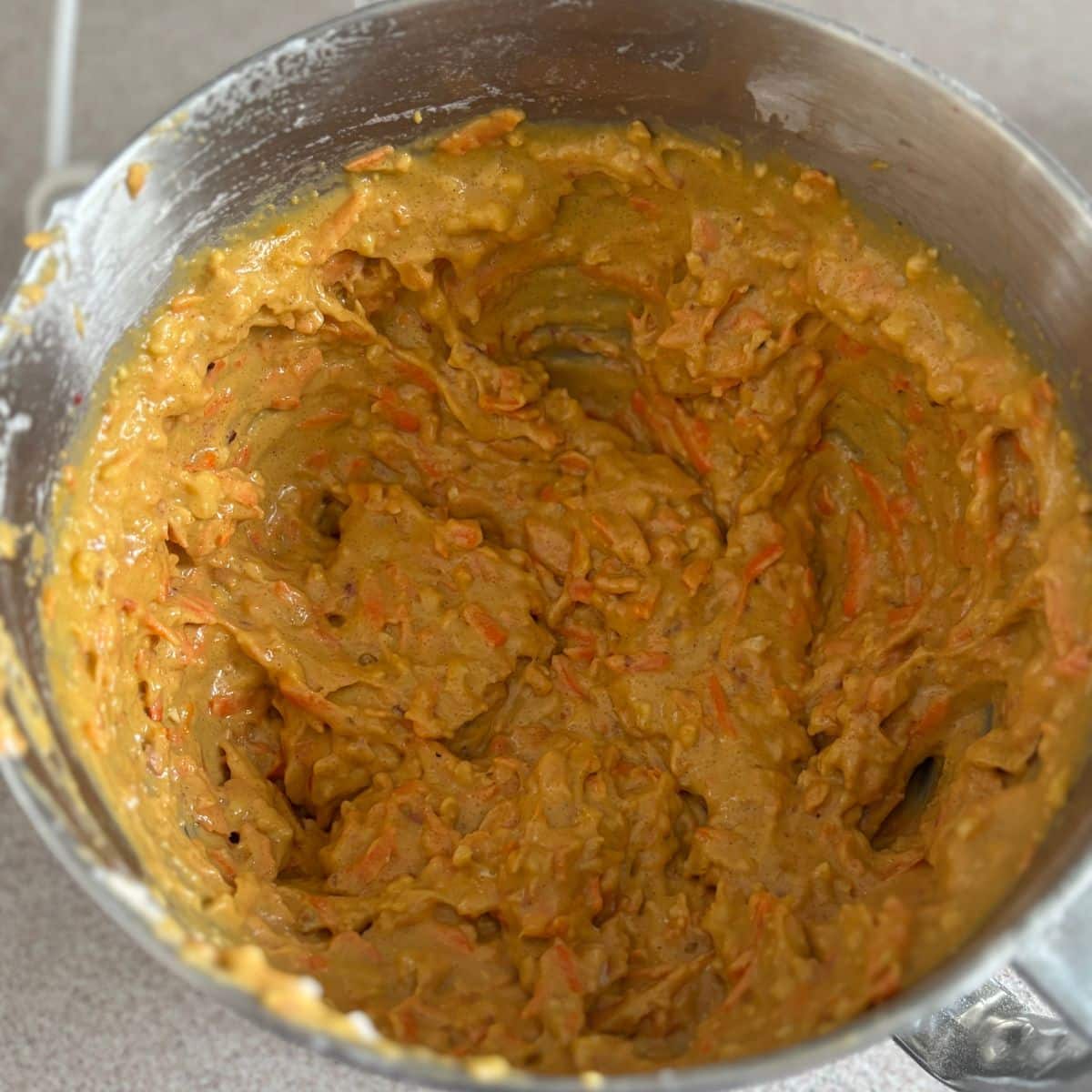 Carrot orange cake batter with carrots, chopped blood oranges, hazelnuts, and olive oil mixed together