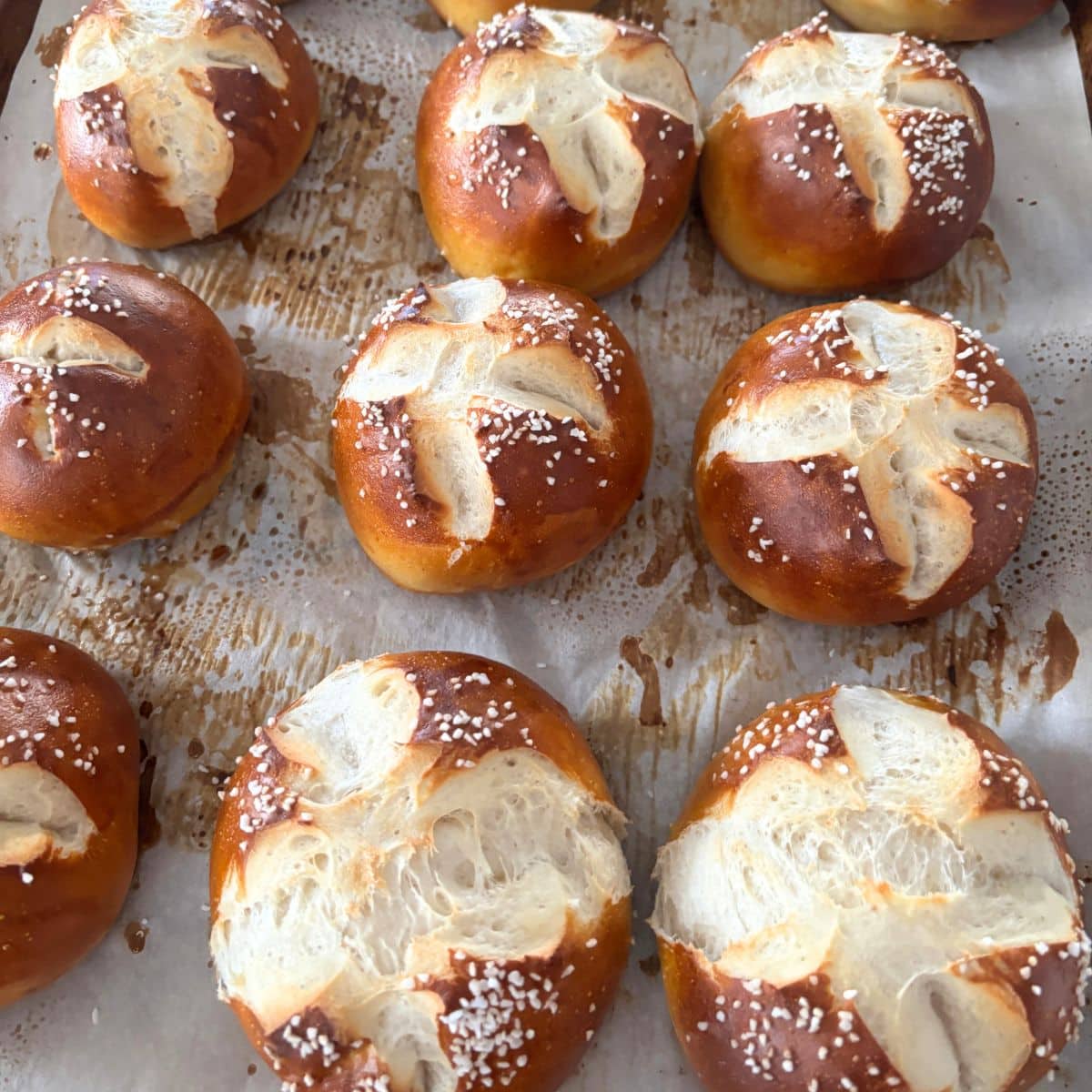 German Pretzel Rolls/ Laugenbrotchen laying on parchment paper