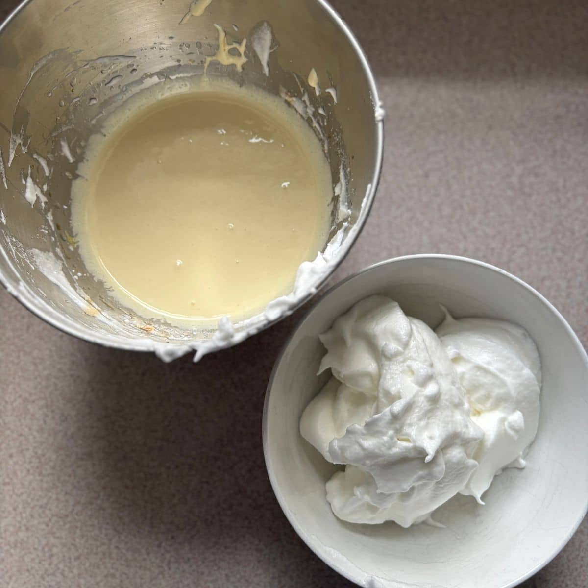 Separated egg whites and egg yolks for making a light sponge cake