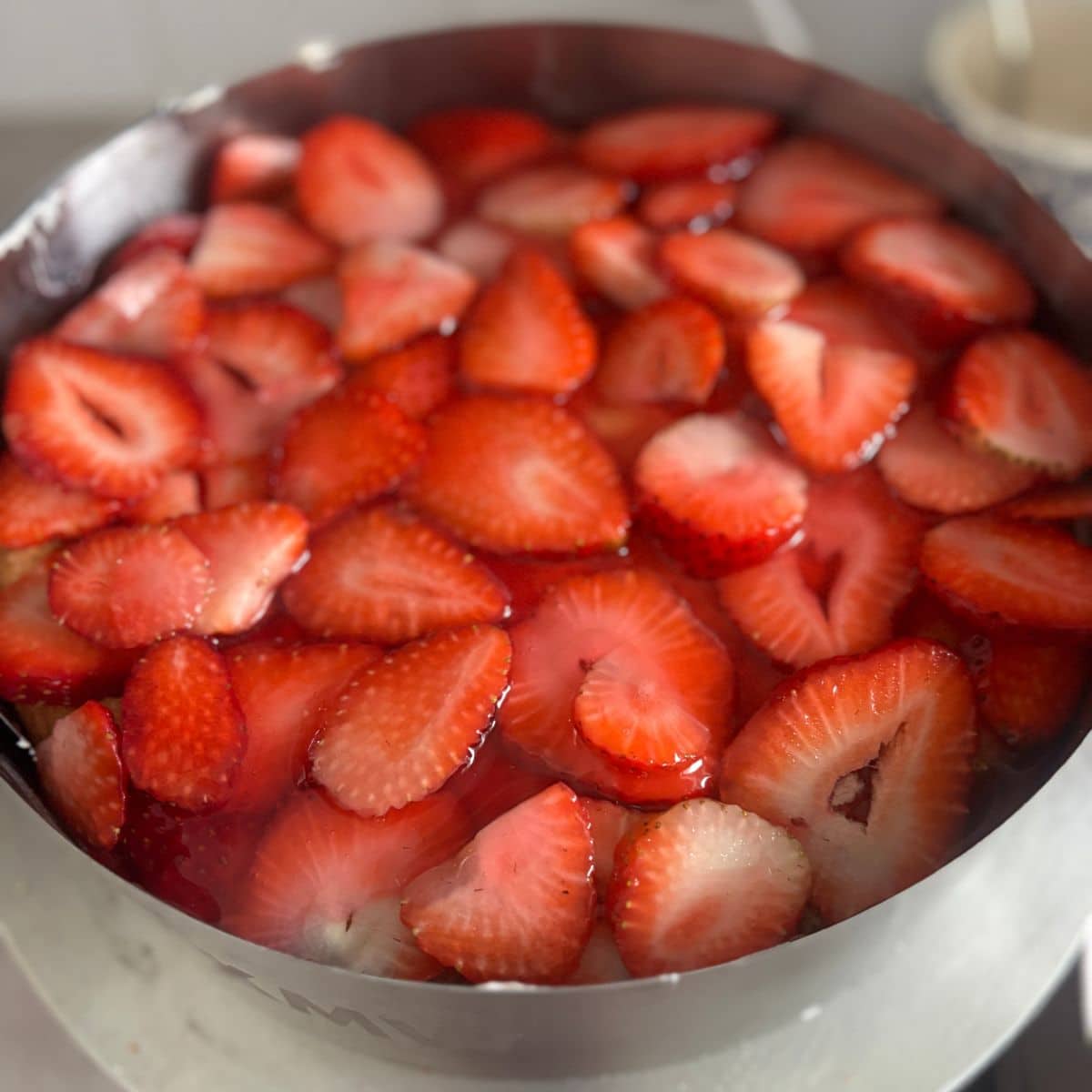 Strawberry mascarpone cake topped with fresh strawberries and German Tortenguss glaze