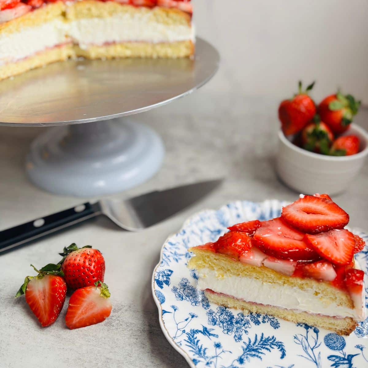 A light and airy strawberry mascarpone cake topped with fresh strawberries and glaze