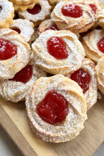 German Marzipan Cookies on wooden board with strawberry jam